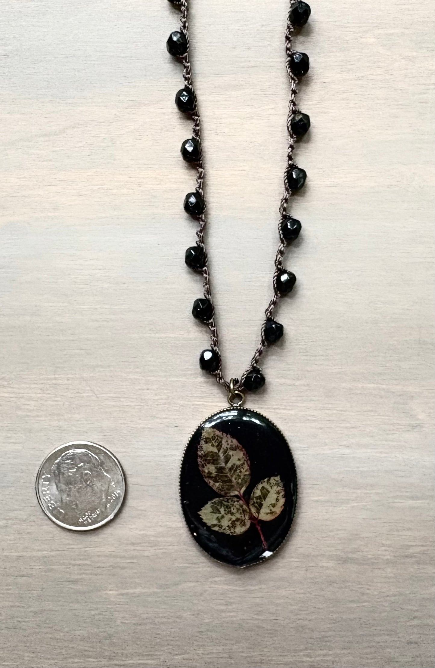 Long Botanical Pendant on Black Crystal, Version 1