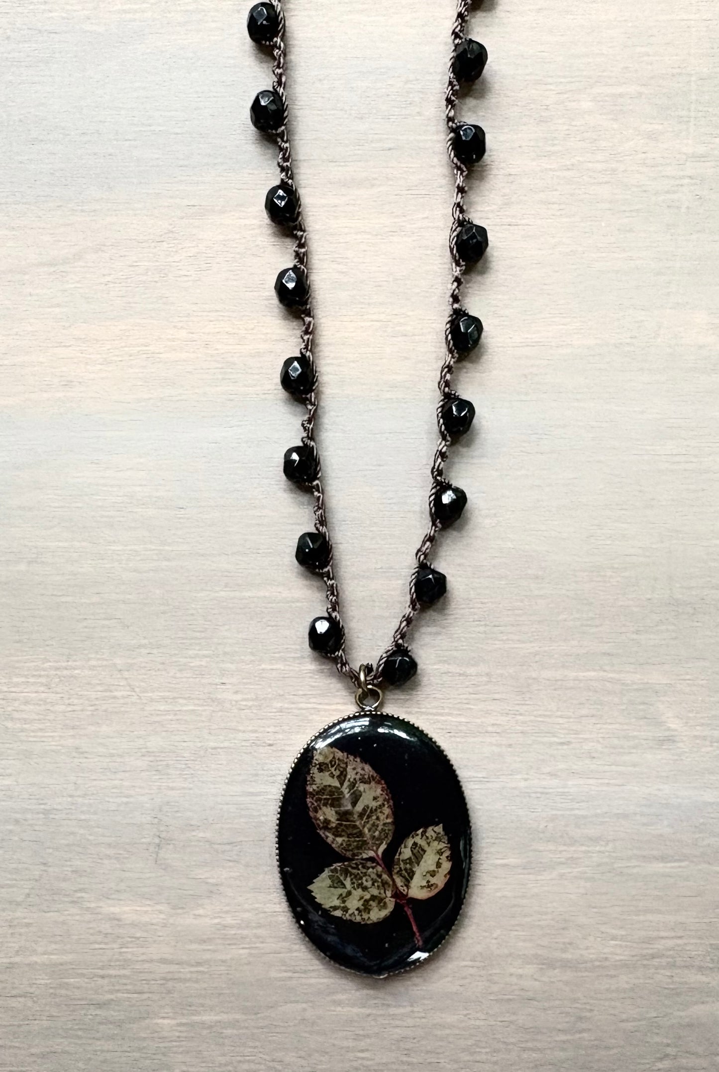 Long Botanical Pendant on Black Crystal, Version 1