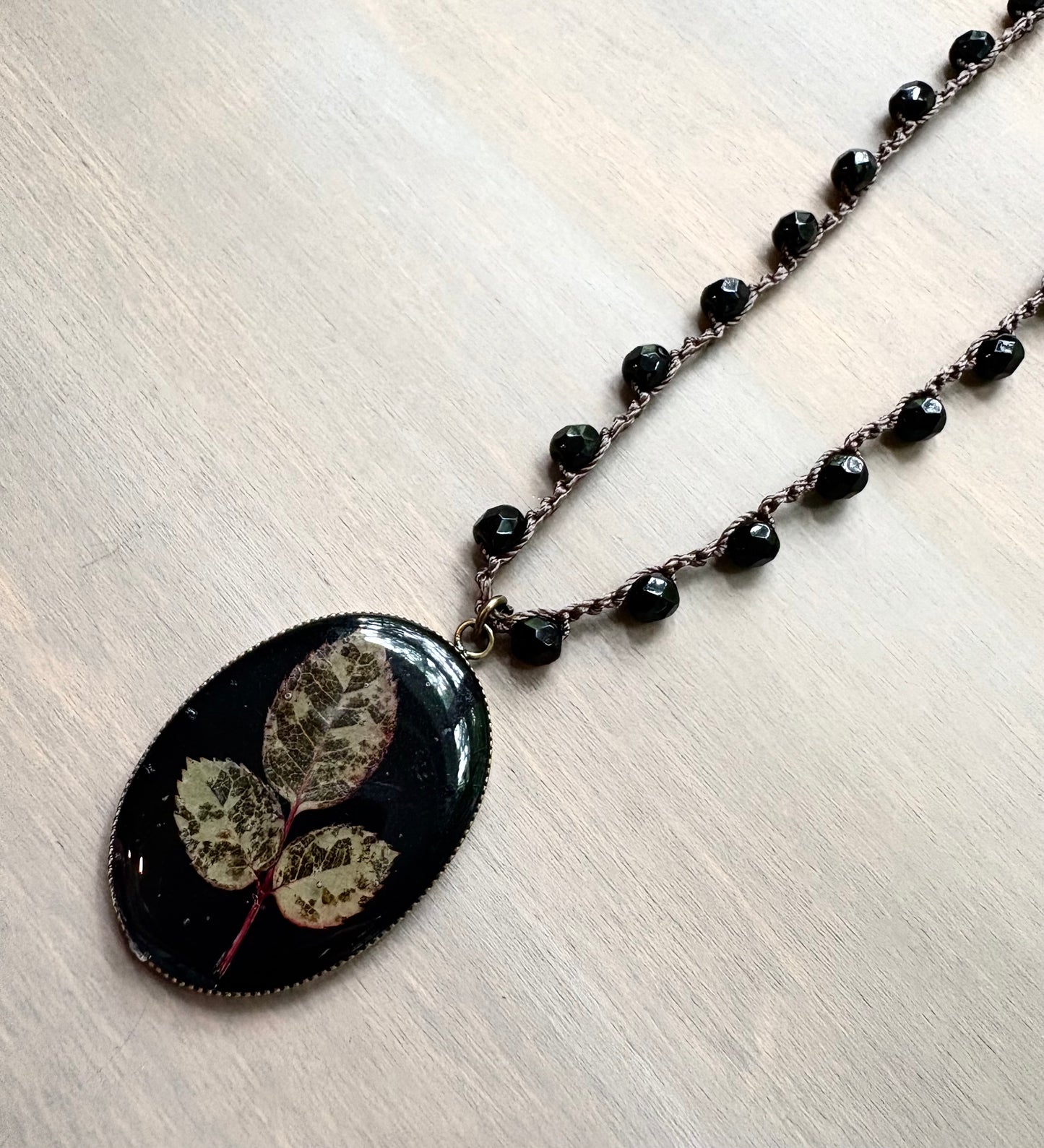Long Botanical Pendant on Black Crystal, Version 1