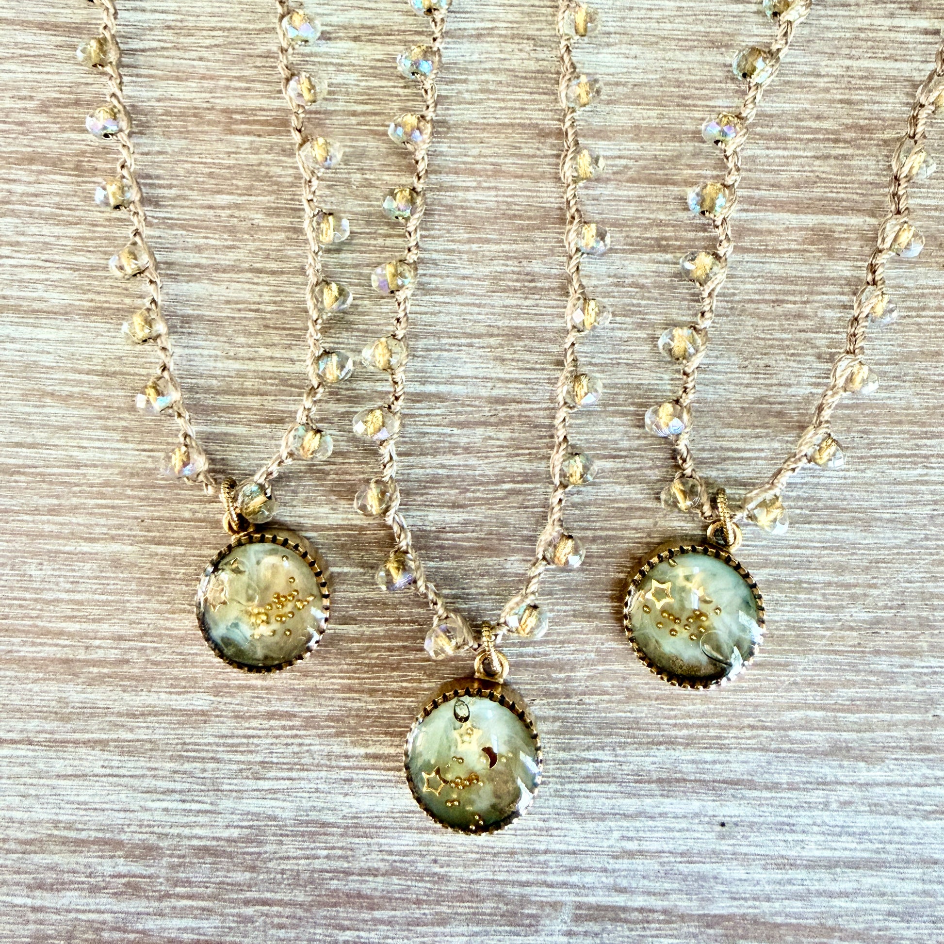 Three handmade necklaces with crystals and stars
