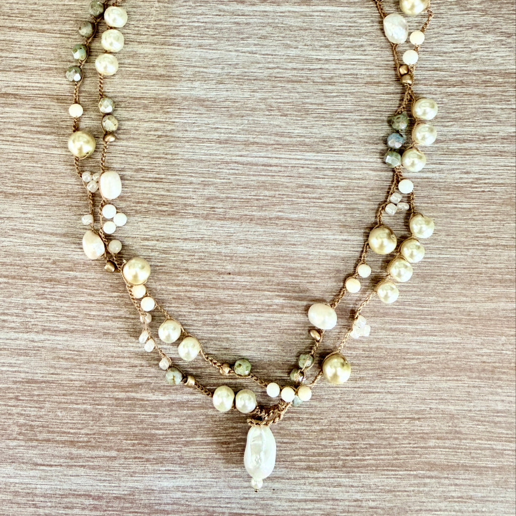 Necklace with pearls on a wooden surface