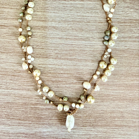 Necklace with pearls on a wooden surface