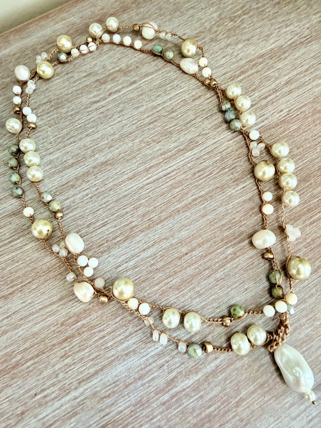 Multistrand pearl necklace on a wooden surface