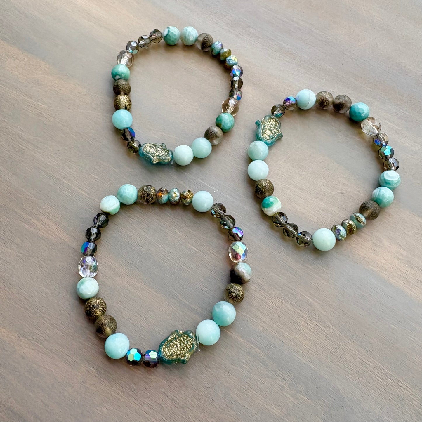 Two beaded bracelets on a wooden surface