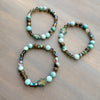 Two beaded bracelets on a wooden surface