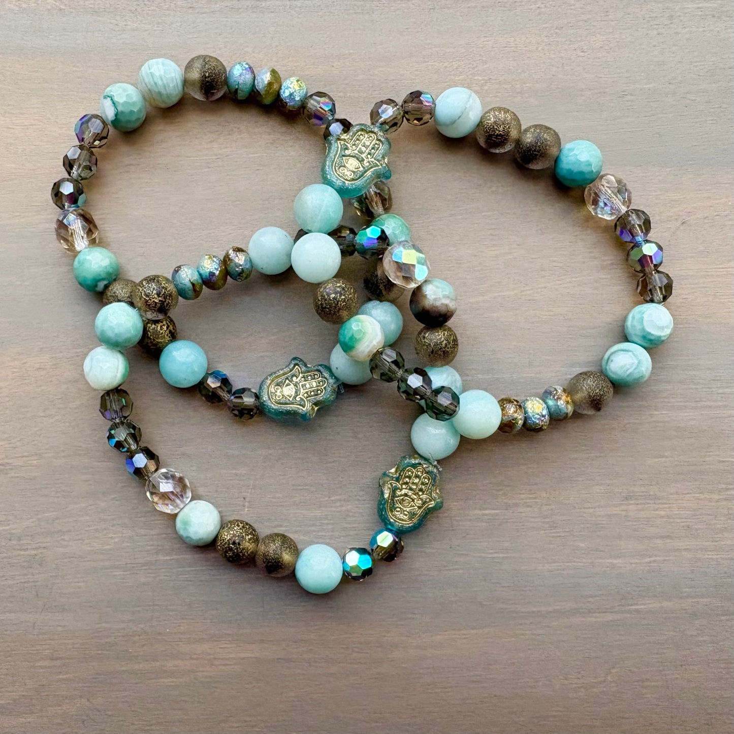 Beaded bracelet with turquoise and brown beads on a wooden surface