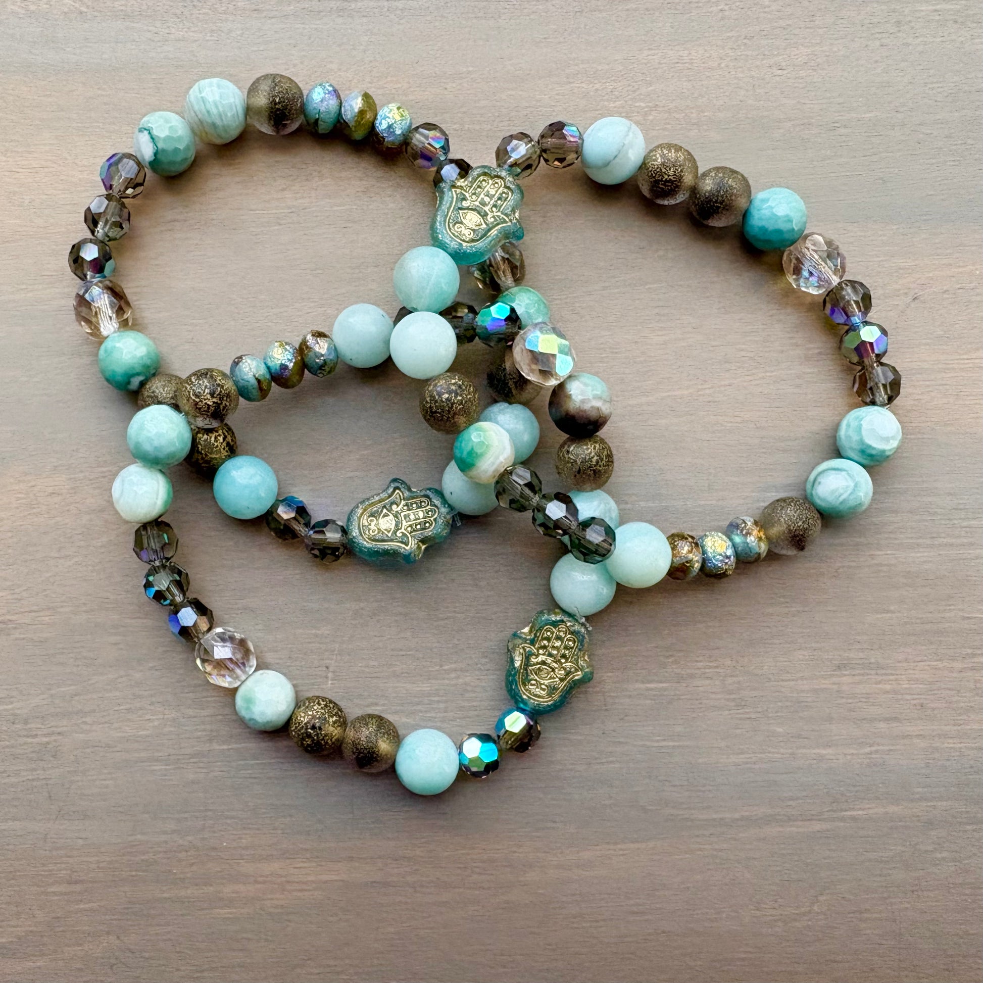 Beaded bracelet with turquoise and brown beads on a wooden surface