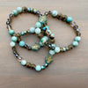Beaded bracelet with turquoise and brown beads on a wooden surface