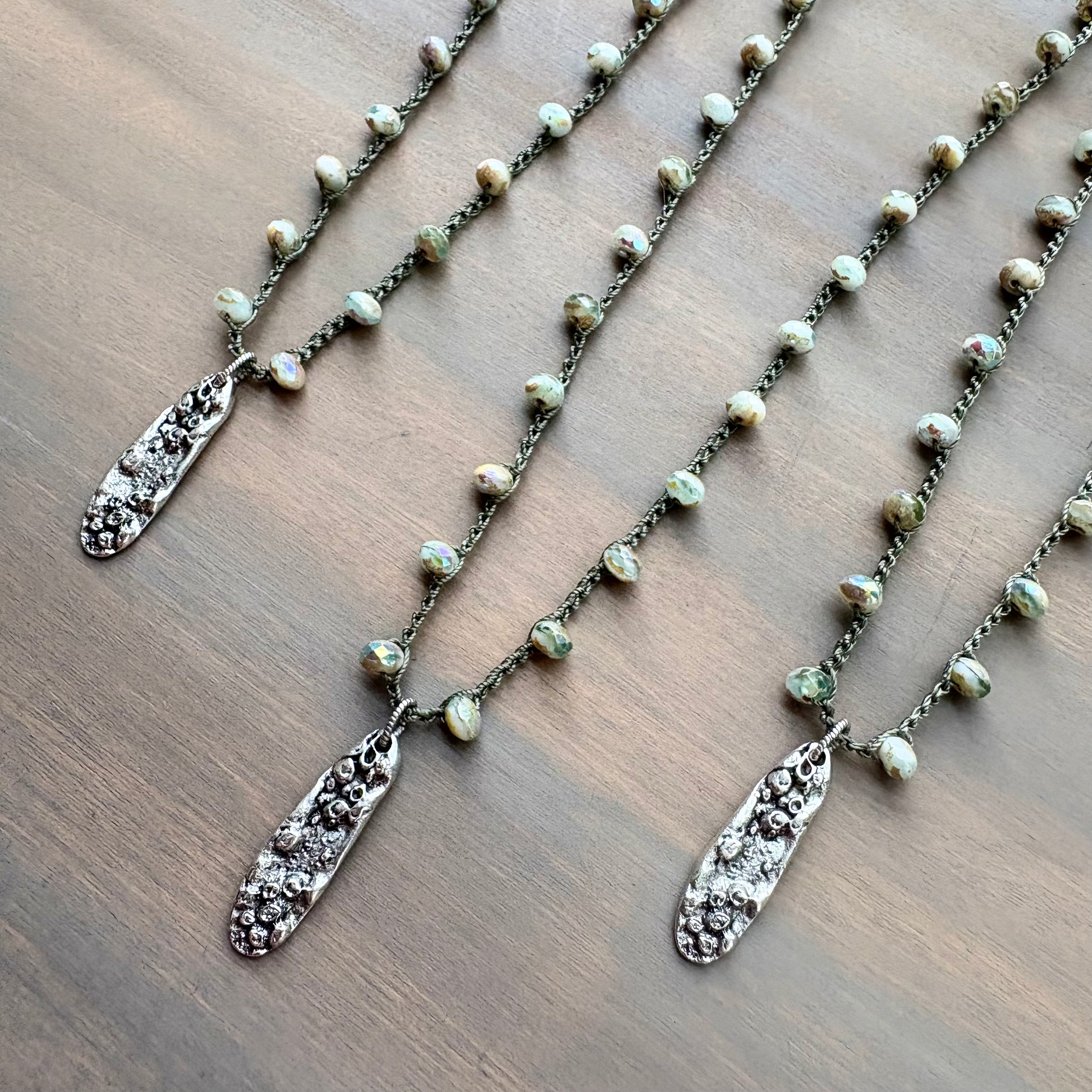 Necklace with pendant on a wooden surface