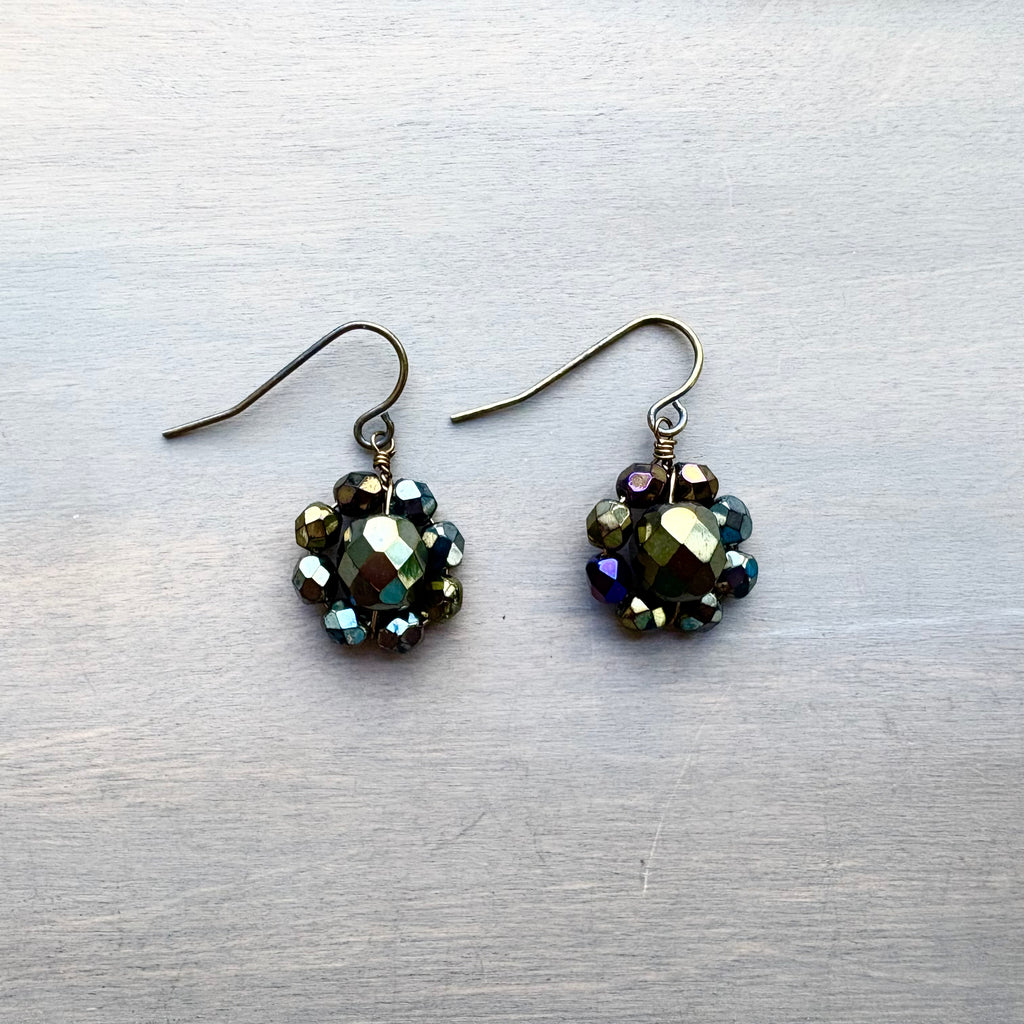 Pair of beaded earrings on a textured gray surface
