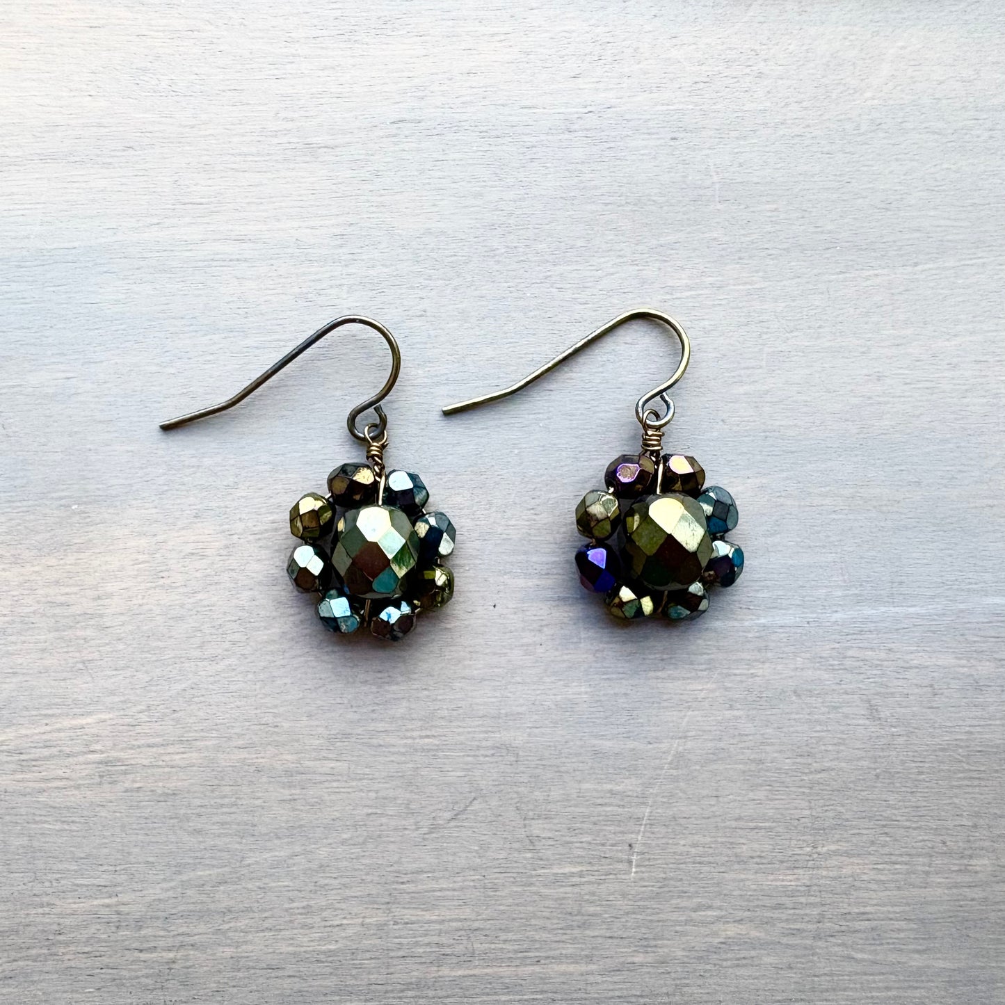 Pair of beaded earrings on a textured gray surface