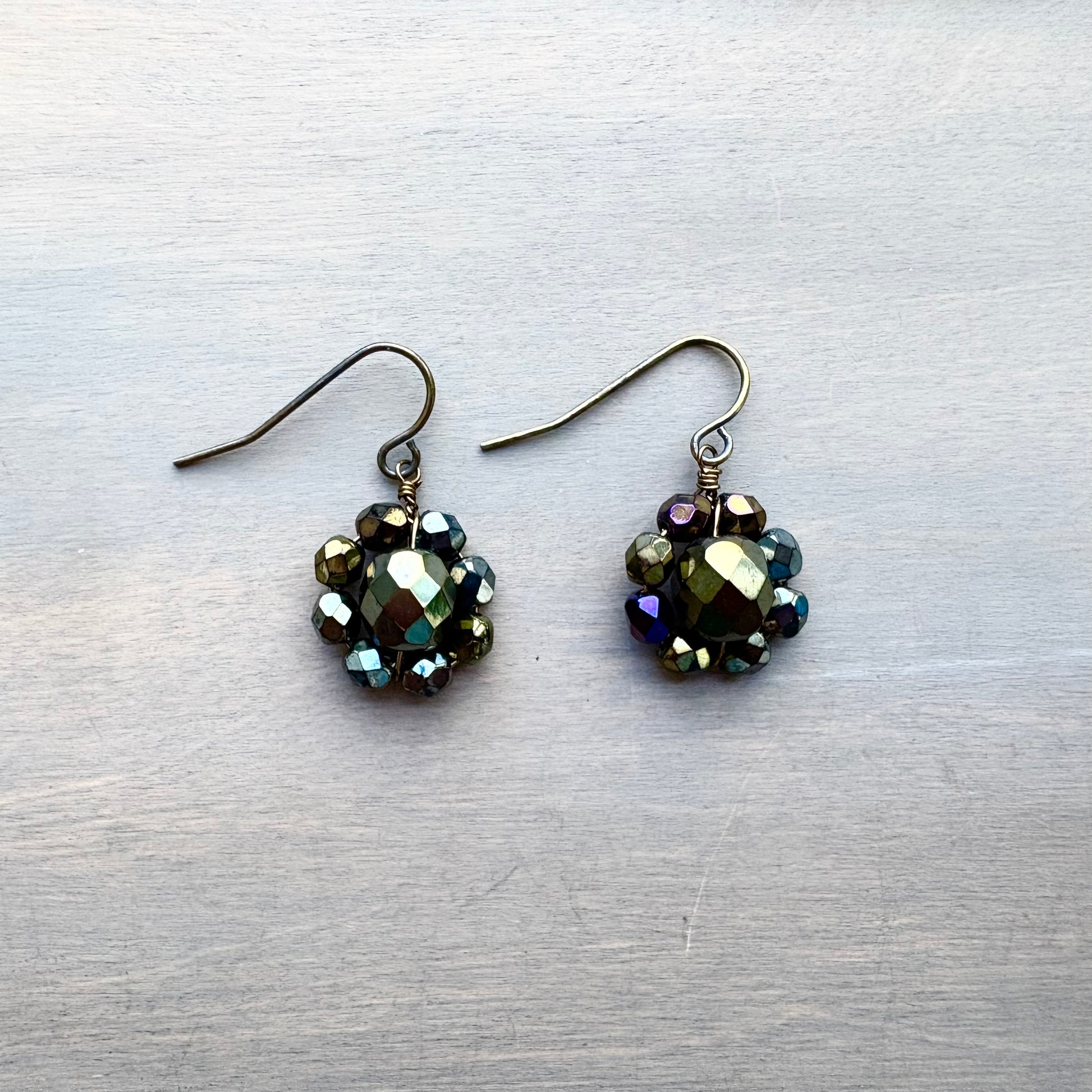 Pair of beaded earrings on a textured gray surface