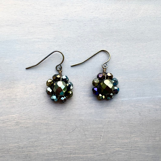 Pair of beaded earrings on a textured gray surface