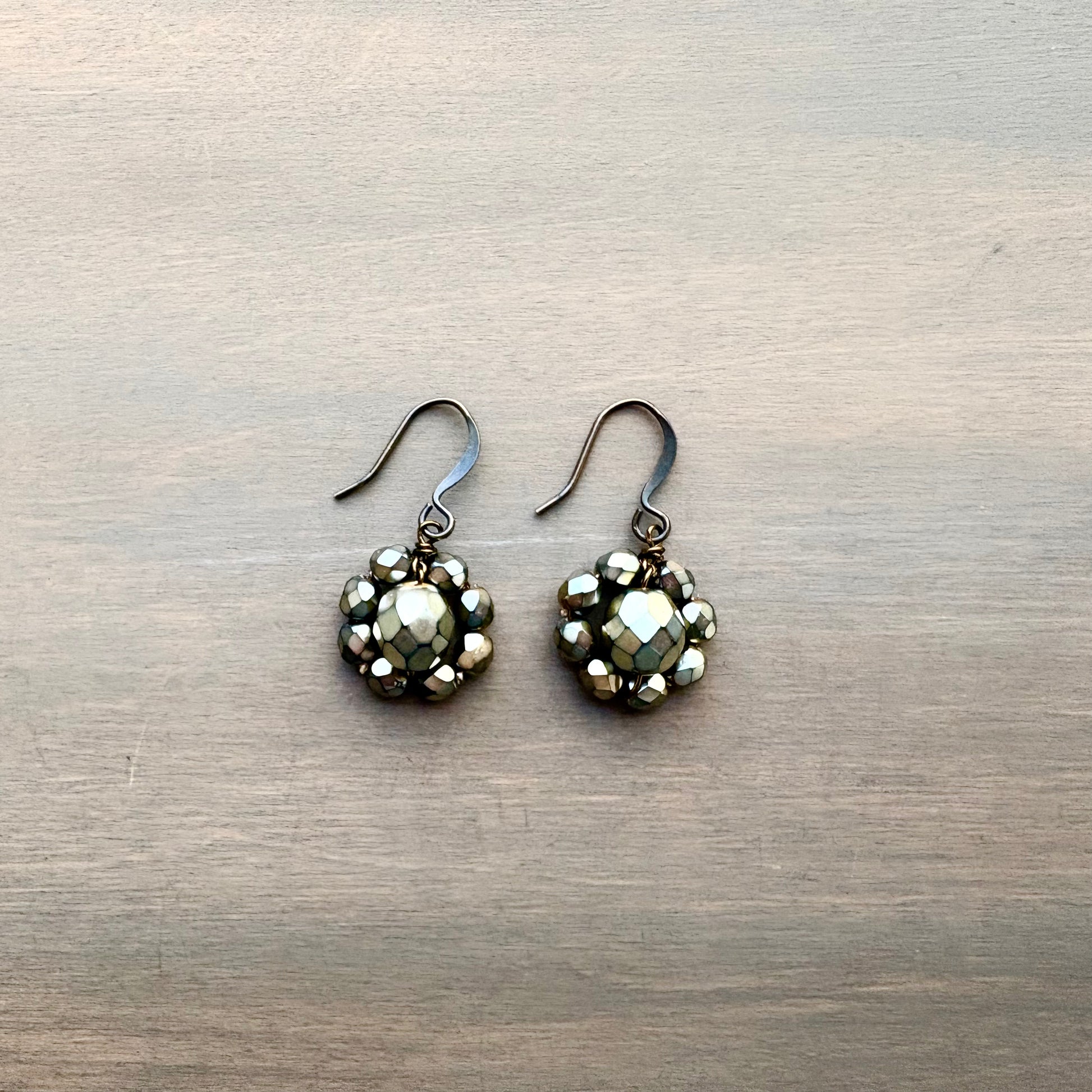 Pair of silver earrings with a textured design on a metallic surface