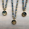 Two beaded necklaces with star-themed pendants on a wooden surface