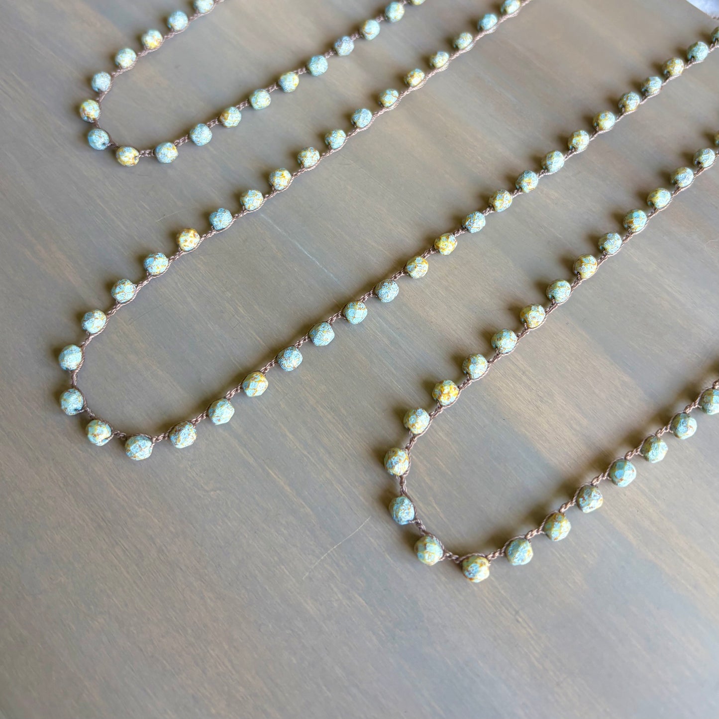 Necklace with small beads on a wooden surface