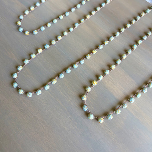 Necklace with small beads on a wooden surface