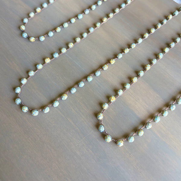 Necklace with small beads on a wooden surface