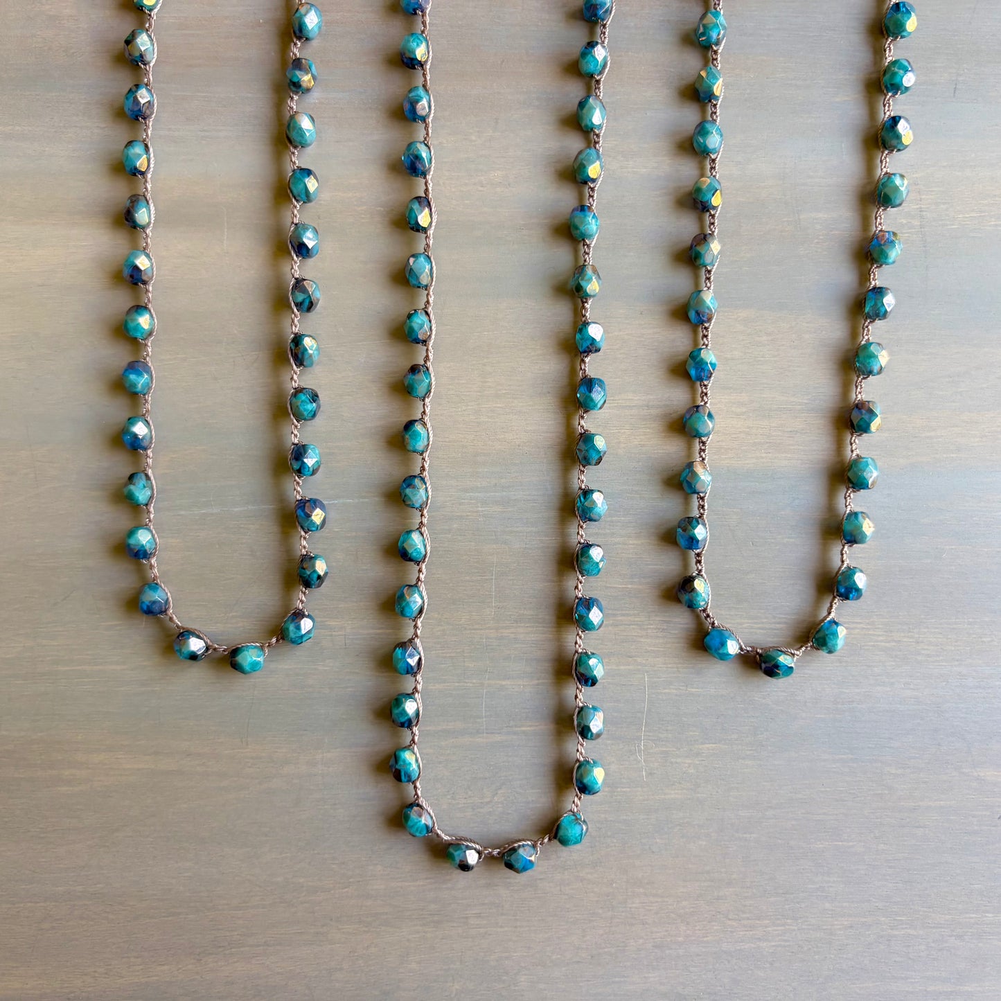 Turquoise beaded necklace on a wooden surface