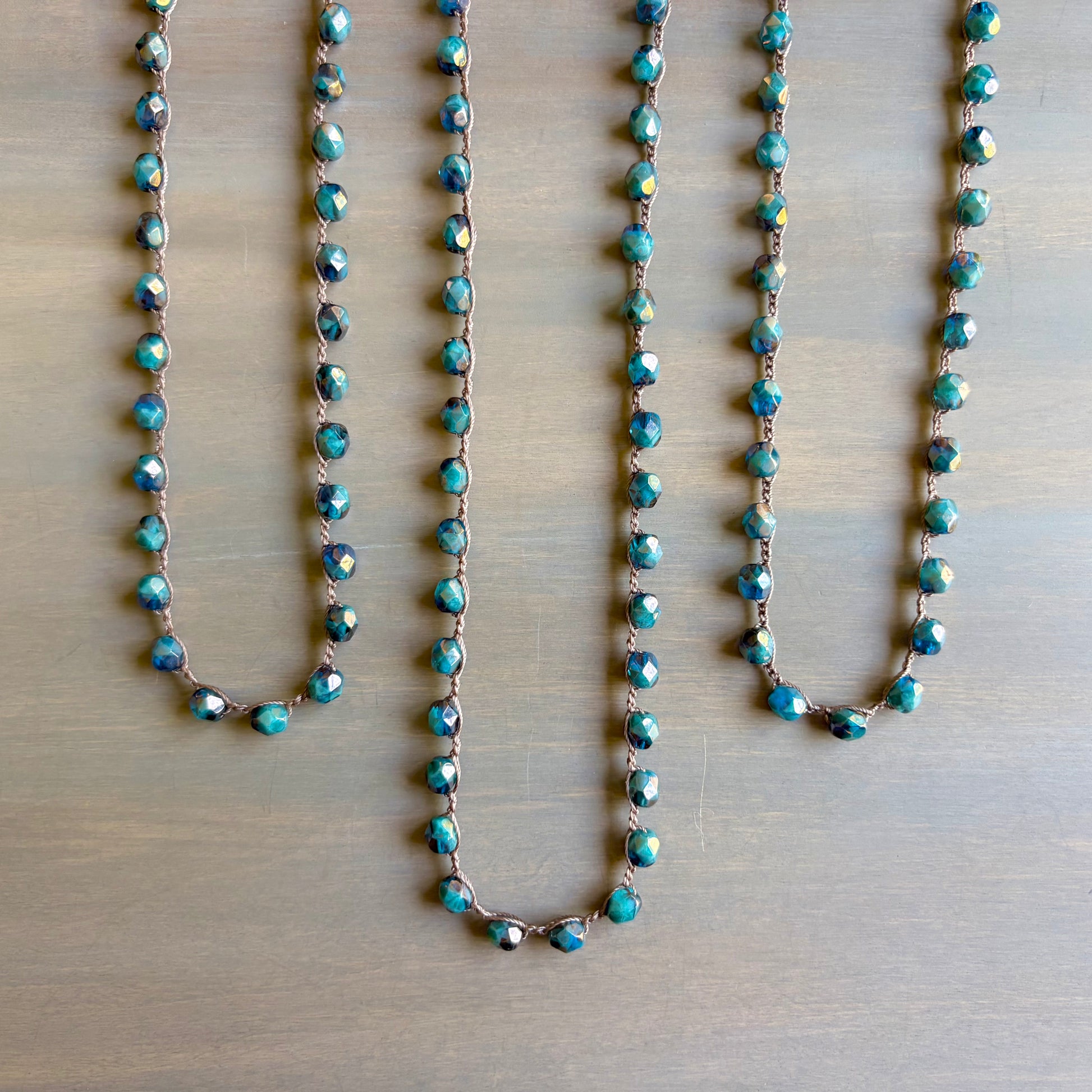 Turquoise beaded necklace on a wooden surface