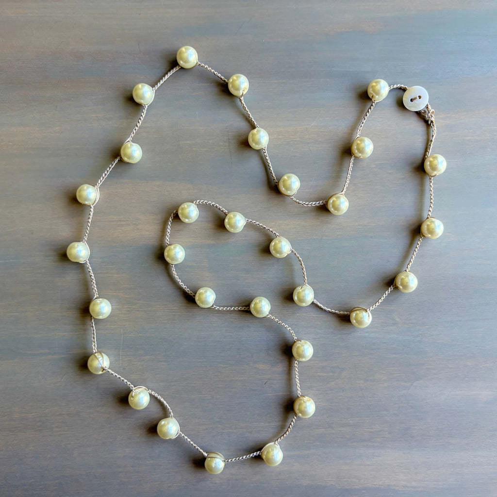 Pearl necklace on a wooden surface