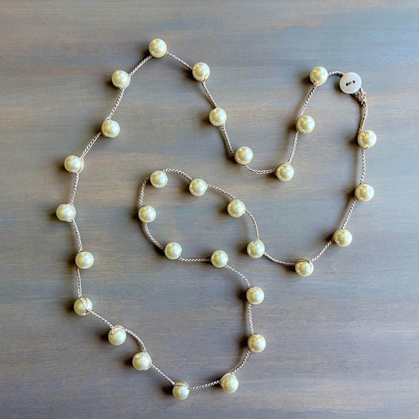 Pearl necklace on a wooden surface