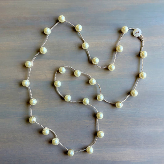 Pearl necklace on a wooden surface