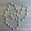 Pearl necklace on a wooden surface